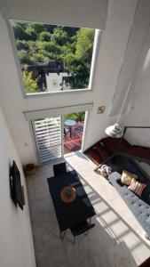 an overhead view of a living room with a large window at Paititi Loft - Solo Adultos in Villa Carlos Paz