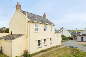 a white house with a grey roof at Charming Upper Solva Cottage by Beaches and Harbour in Solva