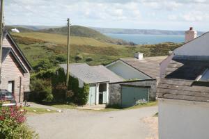 a group of houses with a view of the ocean at Charming Upper Solva Cottage by Beaches and Harbour in Solva