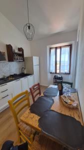a kitchen with a wooden table with pillows on it at La Perla del Boccaccio in Certaldo