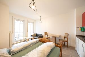 a living room with a bed and a dining room at Appartement Denis in Chemnitz