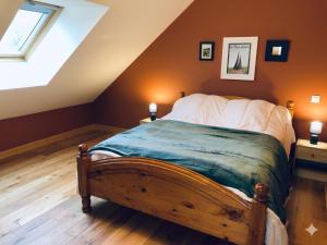 a bedroom with a large bed in a attic at Parfums des peintres proche Crozant - Chambres d'hôtes in Villard +14 photos