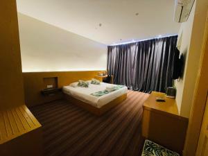 a hotel room with a bed and a window at Melaka City Hotel in Malacca +56 photos