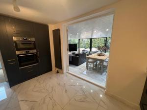a kitchen and dining room with a view of a living room at Beach House Manningtree in Manningtree