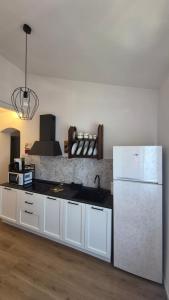 a kitchen with a white refrigerator and a sink at La Perla del Boccaccio in Certaldo +19 photos
