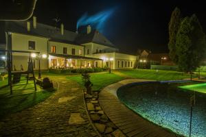 a house with a swimming pool at night at Kúria Beckov - Penzión in Beckov