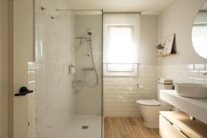 a bathroom with a shower with a toilet and a sink at A Casiña dos Veiras - 3Km antes de Bruma in Santa Eulalia +59 photos