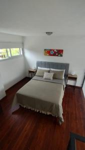 a bedroom with a large bed in a room at Paititi Loft - Solo Adultos in Villa Carlos Paz +75 photos
