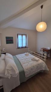 a bedroom with a large bed and a table at La Perla del Boccaccio in Certaldo