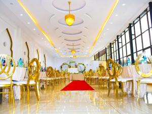 a banquet hall with tables and chairs and a red carpet at Decale Jewel Stone Hotel in Nairobi
