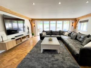 a living room with a couch and a coffee table at The Oaks in Blackburn