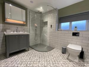 a bathroom with a shower and a toilet and a sink at The Oaks in Blackburn +23 photos