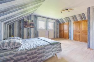 a bedroom with a bed in a room at La Clairière de Dogneville - proche Epinal in Dogneville