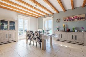 a dining room with a table and chairs at La Clairière de Dogneville - proche Epinal in Dogneville