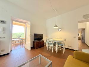 a living room and dining room with a table and chairs at VILLA TRAMONTO in Levanto