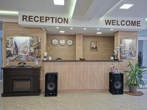 a lobby with a reception desk and a welcome sign at Hotel VIVA in Sofia