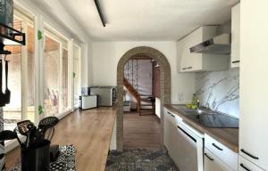 a kitchen with an archway in the middle of a room at Waldhaus zur Kleinbahn in Glashütte