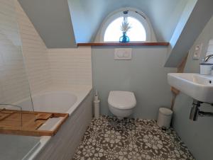 a bathroom with a sink and a tub and a toilet at Ty Bras - 8000 m² de jardin in Camors +23 photos