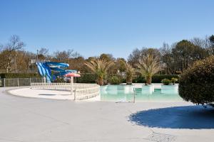 a playground with a slide and a water park at Chalet Solariale in La Teste-de-Buch