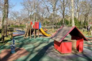 a playground with two slides and a play structure at Chalet Solariale in La Teste-de-Buch