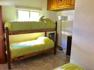 a room with two bunk beds and a window at Complejo Como Vaca in El Chalten