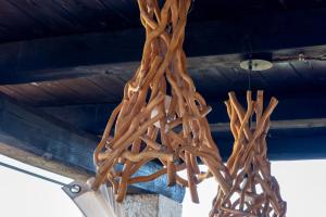 a wooden chandelier hanging from a ceiling at Villa JASMINE SMERALDA in Cala Bitta +89 photos