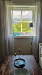 a living room with a table and a window at Leilighet på Bekkeli, Beito. in Beitostøl +18 photos