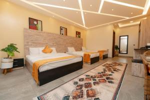 a hotel room with two beds and a rug at pyramids view suite/vista piramidi in Cairo +134 photos