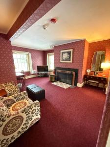 a living room with a couch and a fireplace at Stonehurst Manor Breakfast & Dinner Included in North Conway