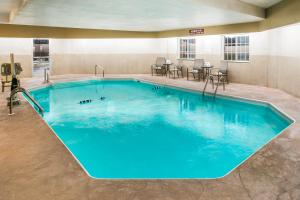 a large pool with blue water in a hotel room at Super 8 by Wyndham Altoona in Altoona