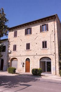 a large brick building with two entrances and a door at 2ª Casa del Borgo Antico in Poggibonsi