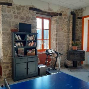 a room with a book shelf and a desk at gite que canta in Saint-Julien-Vocance