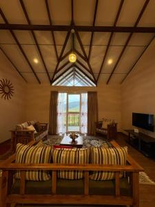 a living room with a couch and a table at 7 Crowns Villa Ambewela, Nuwara Eliya in Boragasketiya