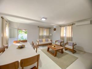 a living room with a table and chairs at Hasoa Villa in Morondava