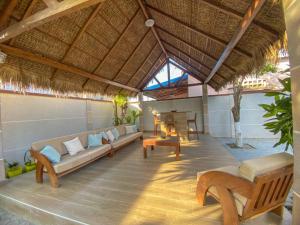 an outdoor living room with a couch and tables at Hasoa Villa in Morondava