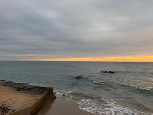 a view of the ocean from the beach at sunset at Sylvia Apartman in La Mata