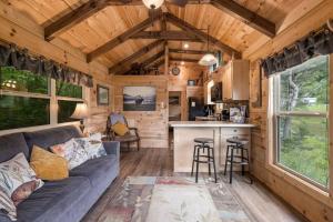 a living room and kitchen of a tiny house at Smoky Mountain Mist, Tiny House, Custom Log Cabin in Bryson City