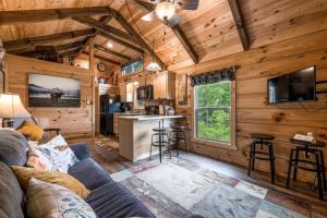 a living room and kitchen in a tiny house at Smoky Mountain Mist, Tiny House, Custom Log Cabin in Bryson City