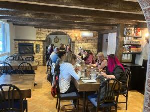 a group of people sitting at tables in a restaurant at Auberge Restaurant du Monde in Nominingue