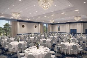 a banquet hall with white tables and chairs and chandeliers at Ashore Oceanfront Hotel by Marriott in Ocean City +100 photos