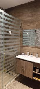 a bathroom with a sink and a mirror at Villa AM in Awlād ‘Umar +19 photos