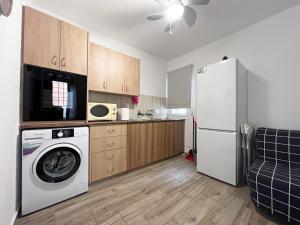 a kitchen with a washing machine and a refrigerator at Albert's apartment Center 101 in Larnaca