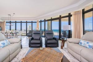 a living room with two couches and a table at The Oasis 411 formerly Phoenix West II 411 in Orange Beach +95 photos