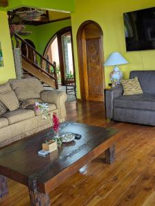 a living room with a couch and a coffee table at Villa Siempre Aventura in Nuevo Arenal