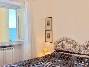 a bedroom with a bed and a window at VILLA TRAMONTO in Levanto