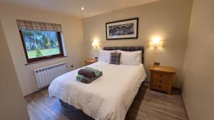 a bedroom with a bed with a stuffed animal on it at Bunroy Park in Fort William