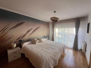 a bedroom with a white bed and a window at Pegadas no mar in Ribeira +34 photos