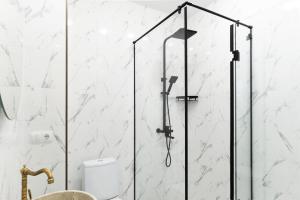 a glass shower in a bathroom with a toilet at Sky by the river in Tbilisi City +84 photos
