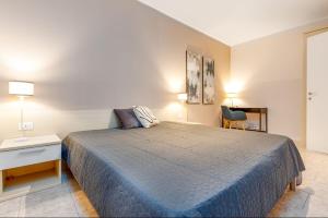 a bedroom with a bed and a table and a chair at HB Appartamenti in centro Bergamo in Bergamo