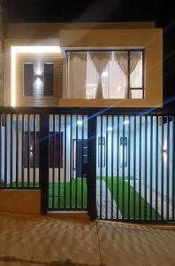 a front door of a house with a gate at Casa moderna, amplia y acogedora Valentina in Loja